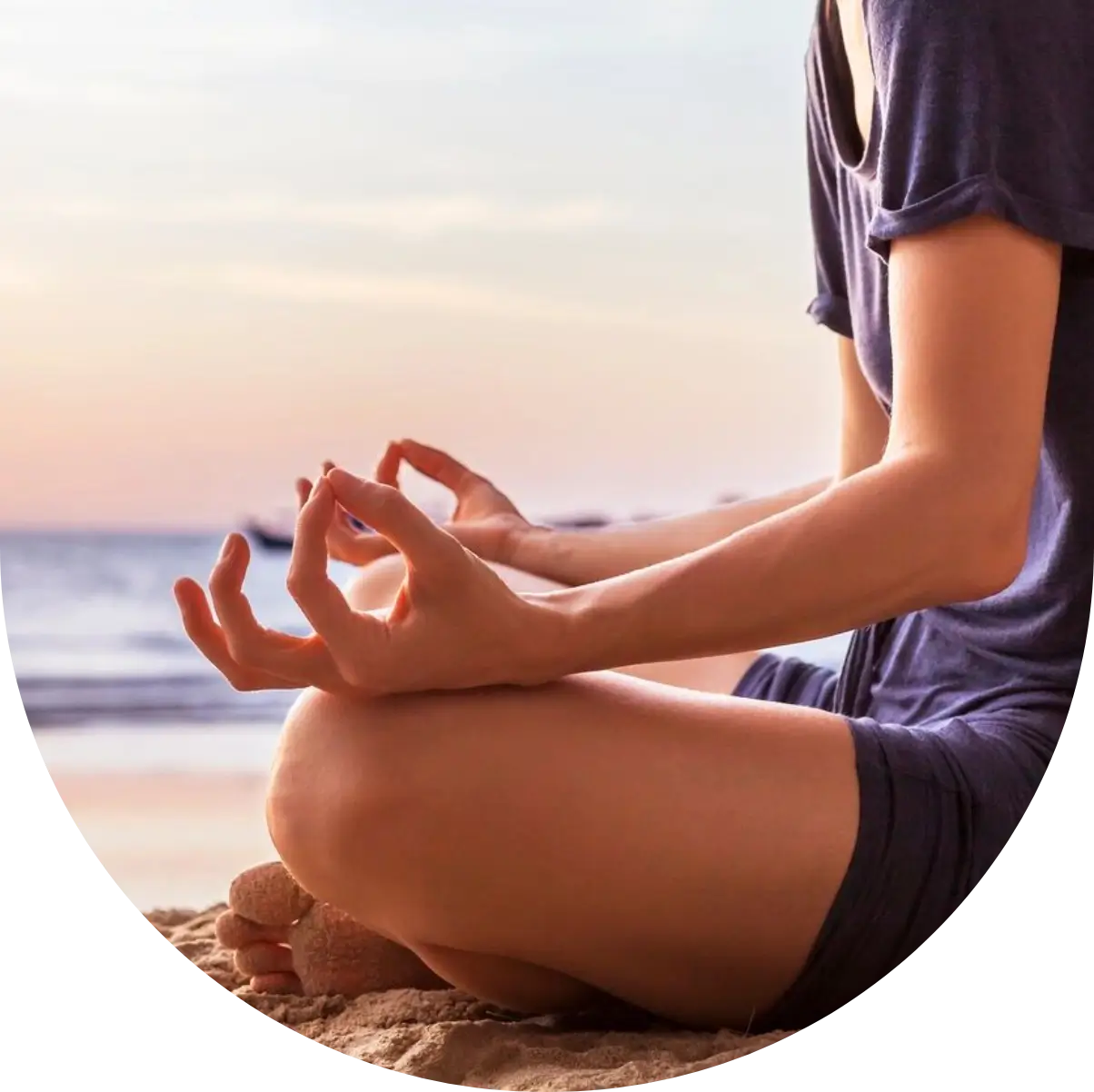 A person sitting on the ground with their hands in the air.