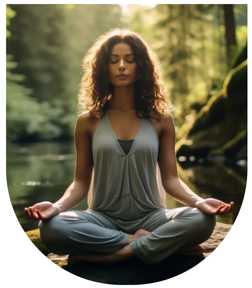 A woman sitting in the lotus position on top of a rock.
