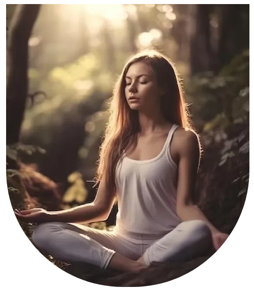A woman sitting in the middle of a forest.