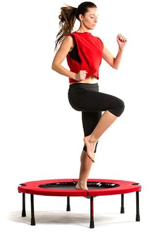Woman exercising on a mini trampoline.