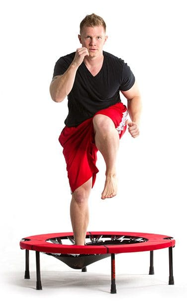 Man exercising on a mini trampoline.