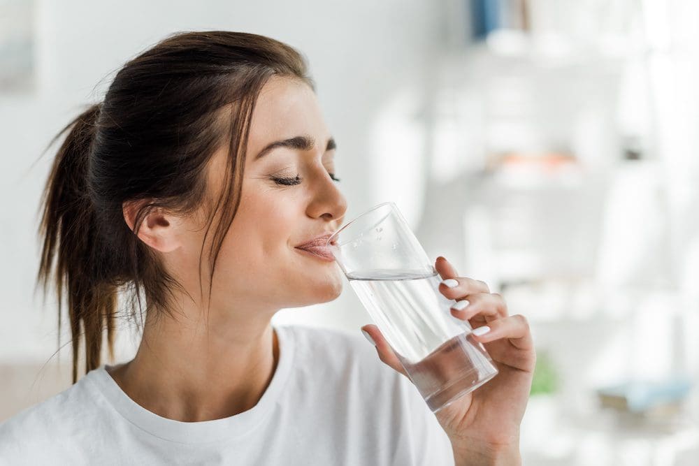 Woman drinking a glass of water.