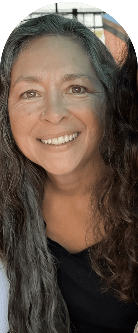 Smiling woman with long, wavy hair.