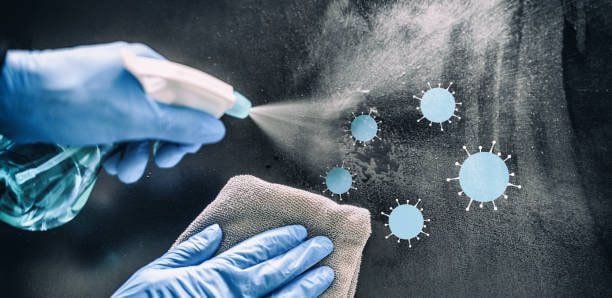 Disinfecting surface with spray and cloth.